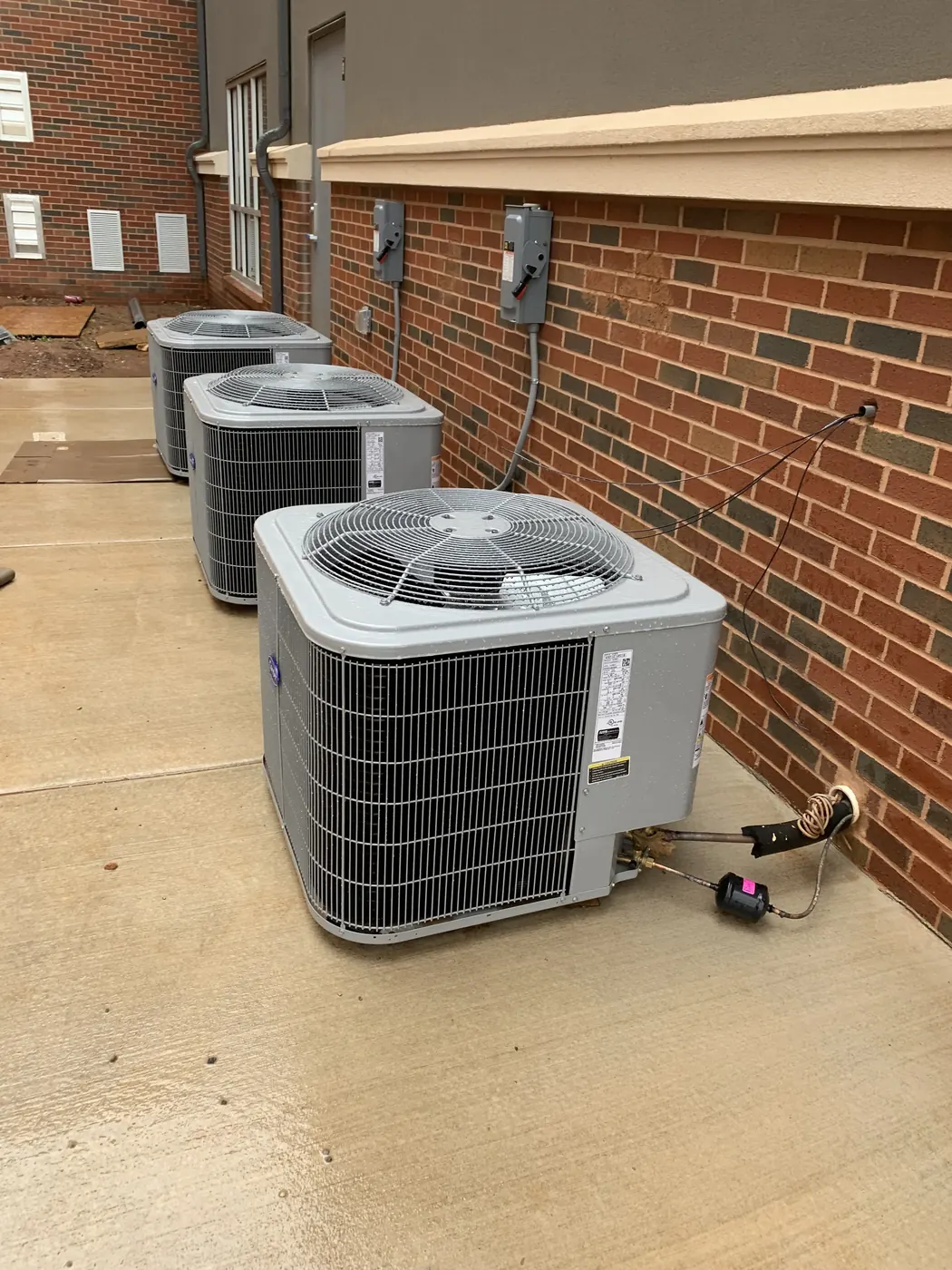 A row of outdoor condensing units at an Oklahoma City commercial property