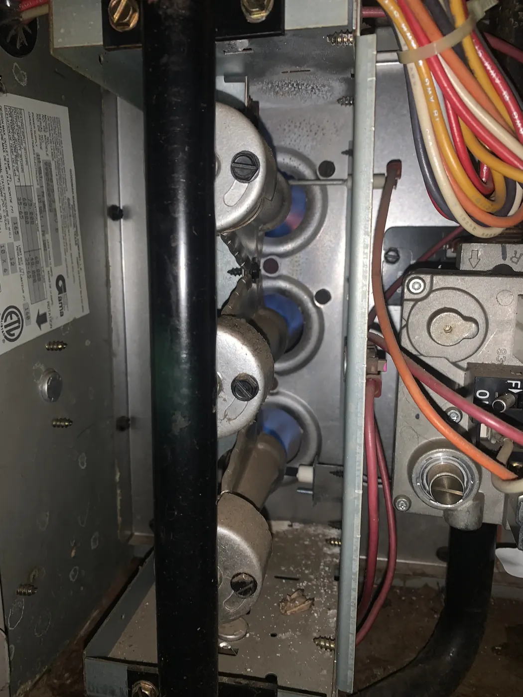 A gas furnace opened up for a repair diagnosis