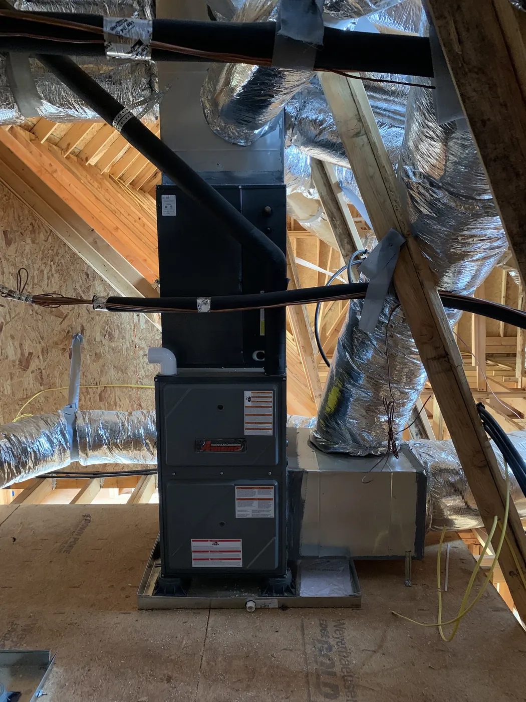 A furnace and connected ductwork installed in an attic