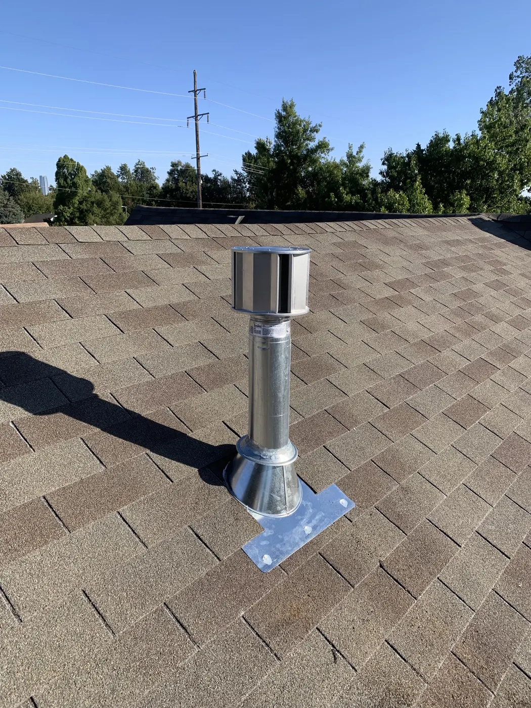 An HVAC flue vent installed on a residential roof