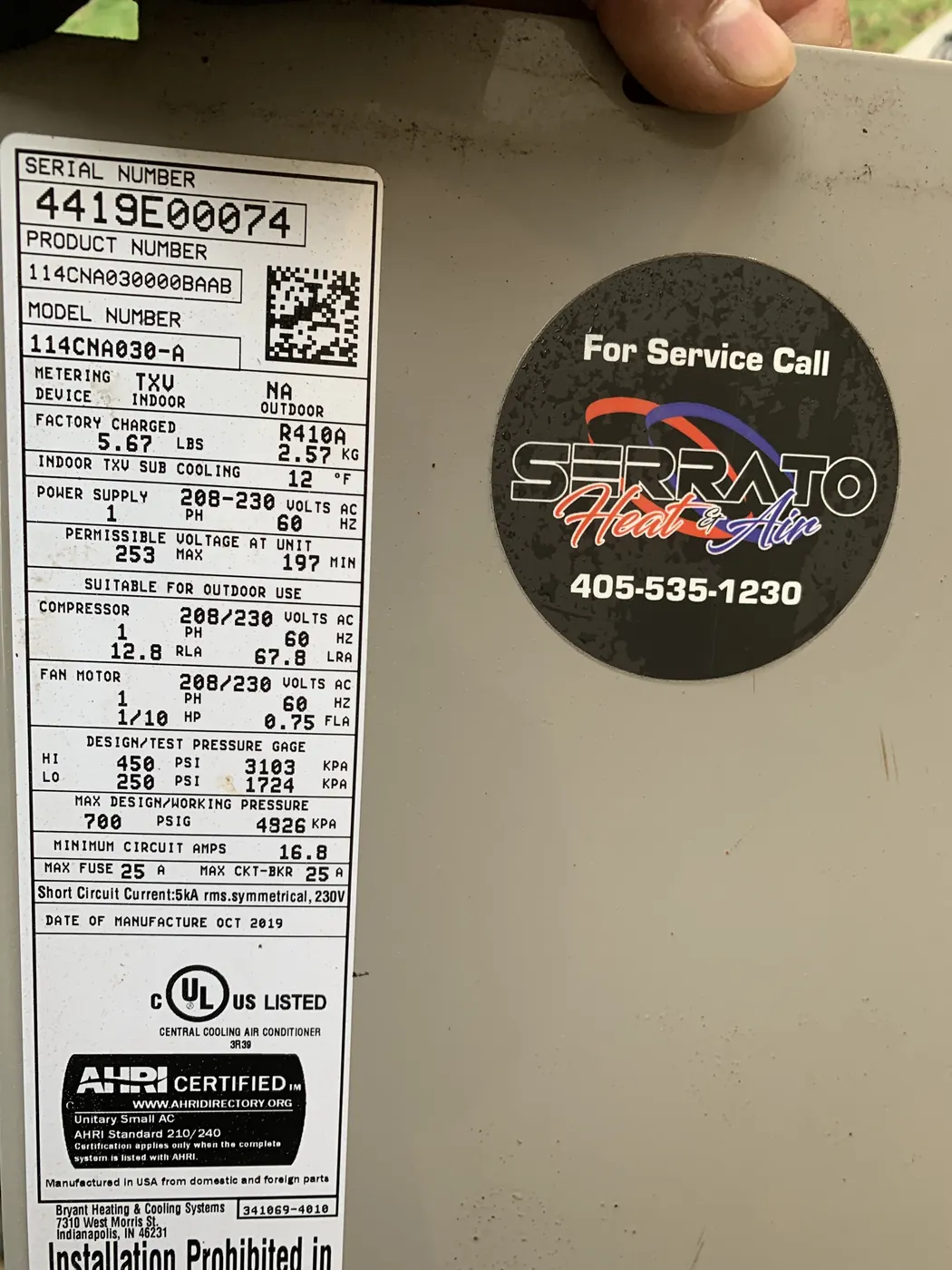 A Serrato Heat and Air service label placed on a serviced HVAC unit